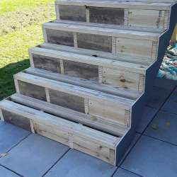 Locking in DekTek's concrete deck tiles installed on stairs with aluminum edge trim in Burnsville, MN