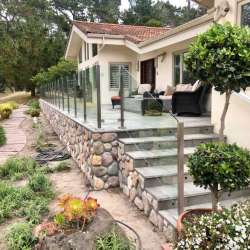 Locking in DekTek Tile's fire proof concrete deck tiles on deck install & stairs with aluminum edge trim in Pebble Beach California